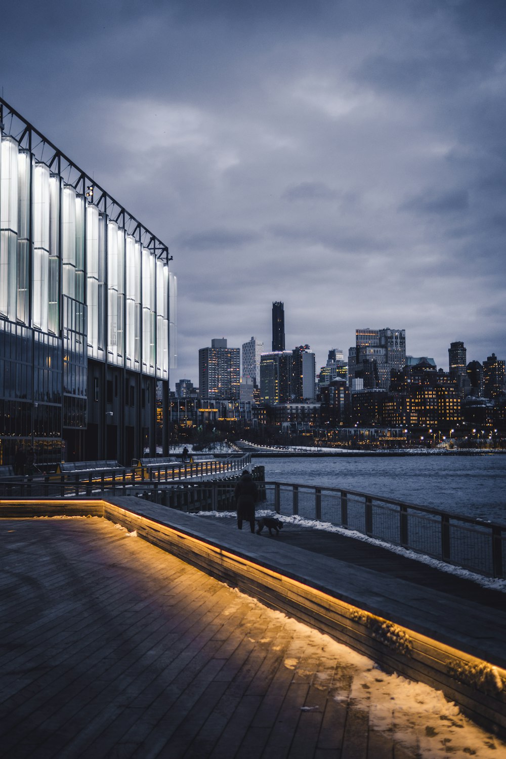 a large building with a lot of windows next to a body of water