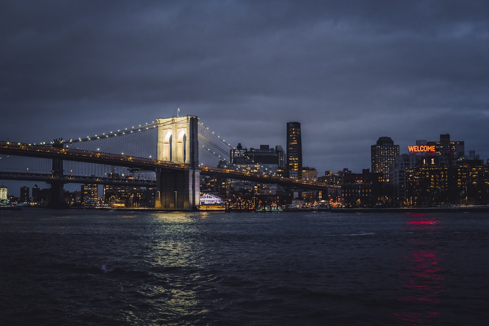 a view of a bridge over a body of water at night