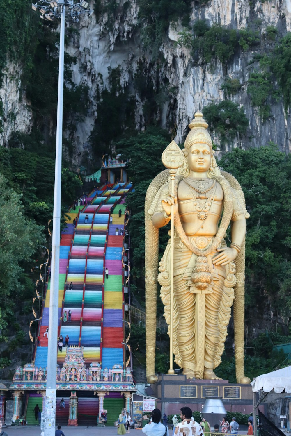 a giant statue of a god in front of a mountain