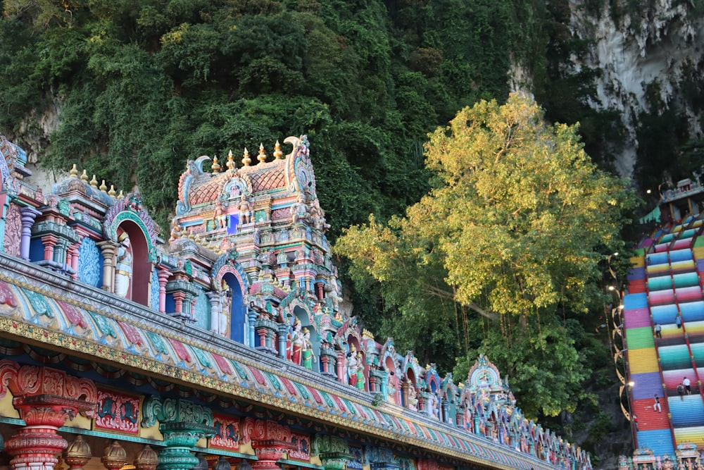 a colorfully painted building with a tree in the background