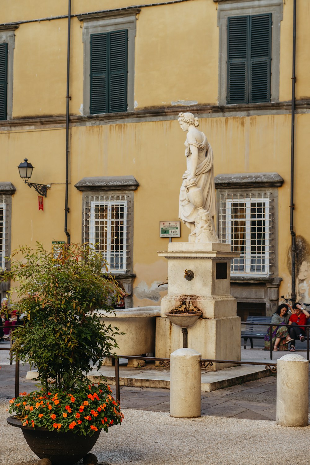 a statue of a woman in front of a building