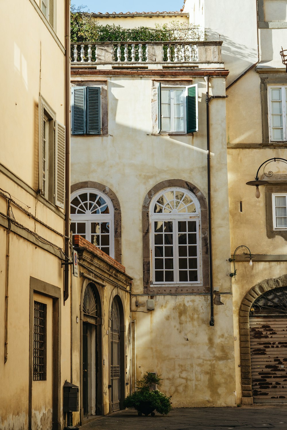 an old building with arched windows and shutters