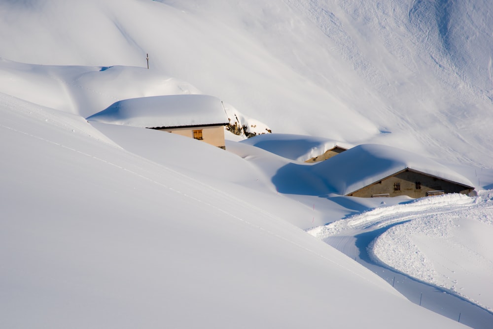 a house in the middle of a snow covered mountain