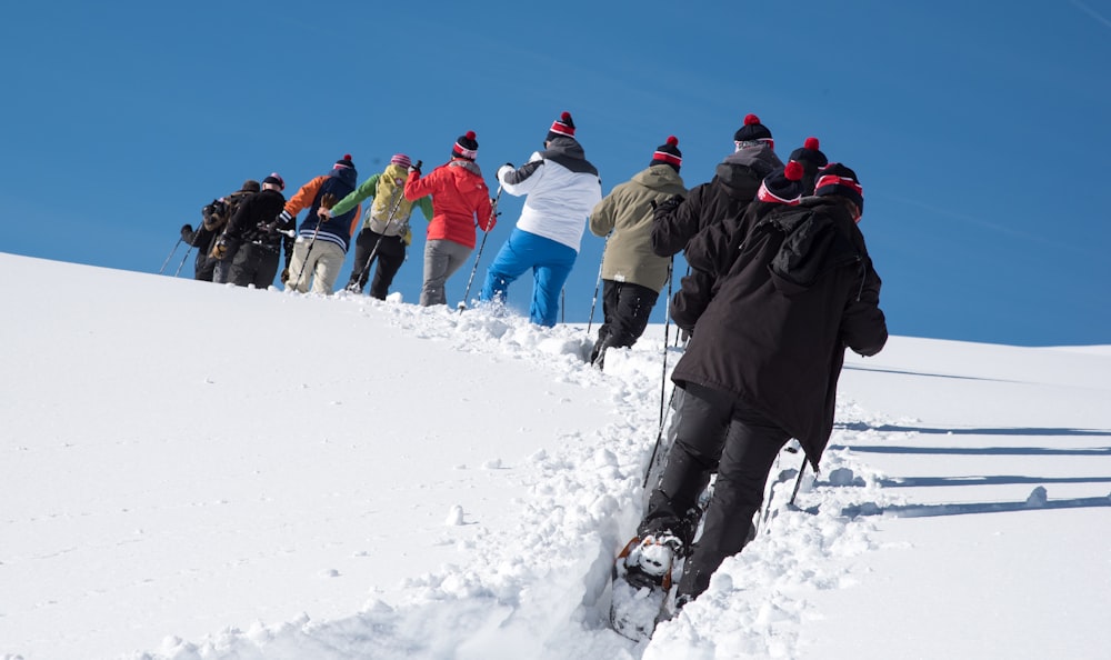 a group of people standing on top of a snow covered slope