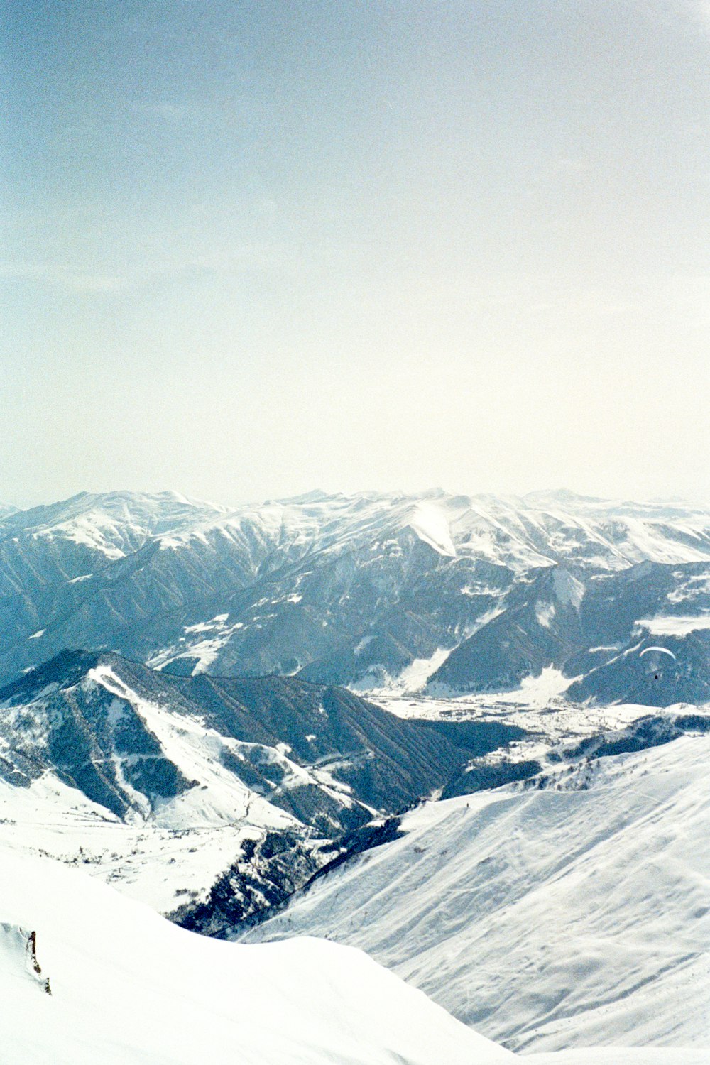 a person on skis standing on top of a snow covered mountain