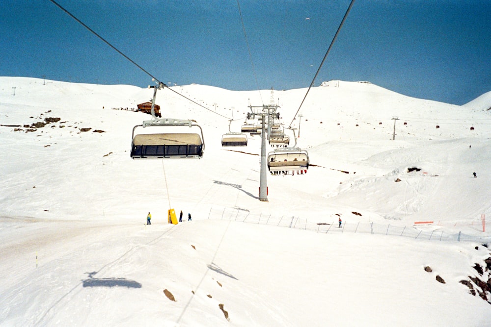 a ski lift going up a snowy mountain