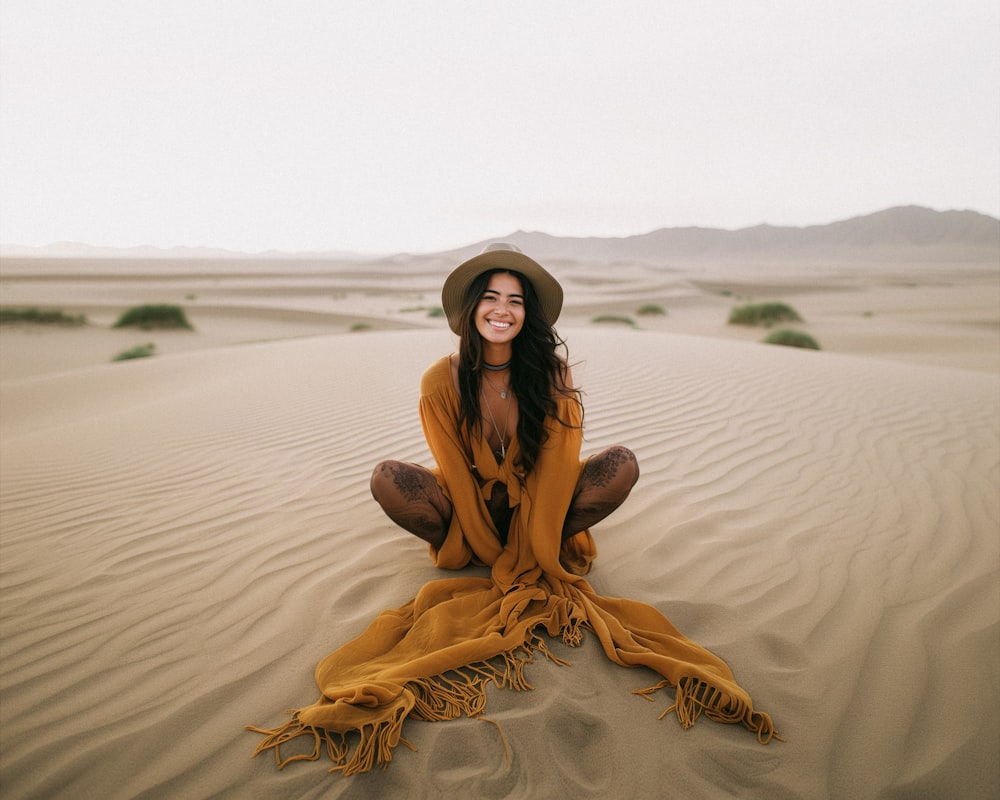 a woman sitting in the middle of a desert