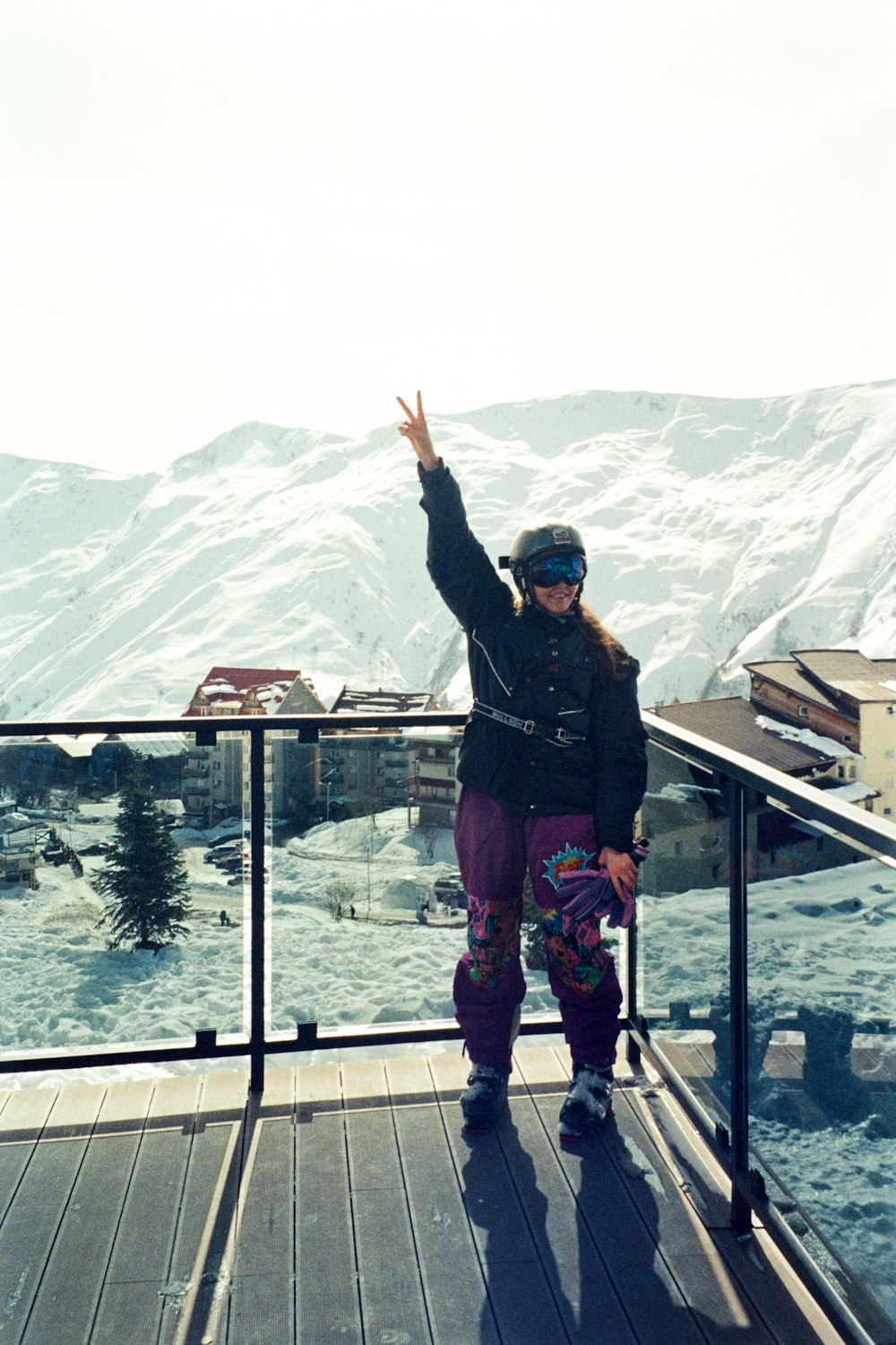 a woman standing on top of a wooden deck