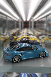 a blue toy car sitting on top of a shelf