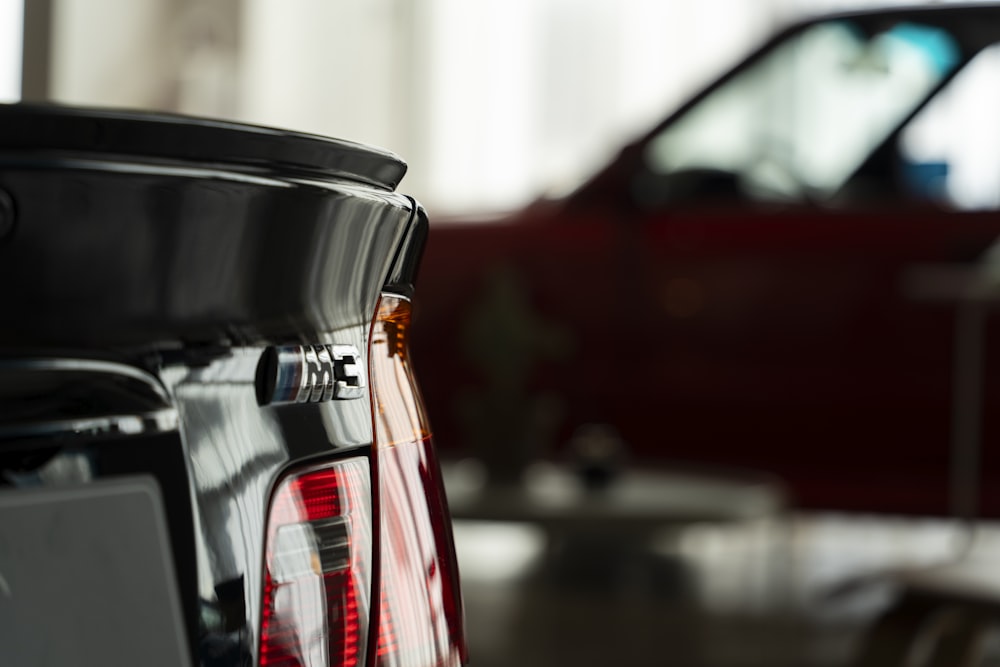 the tail lights of a red car in a showroom