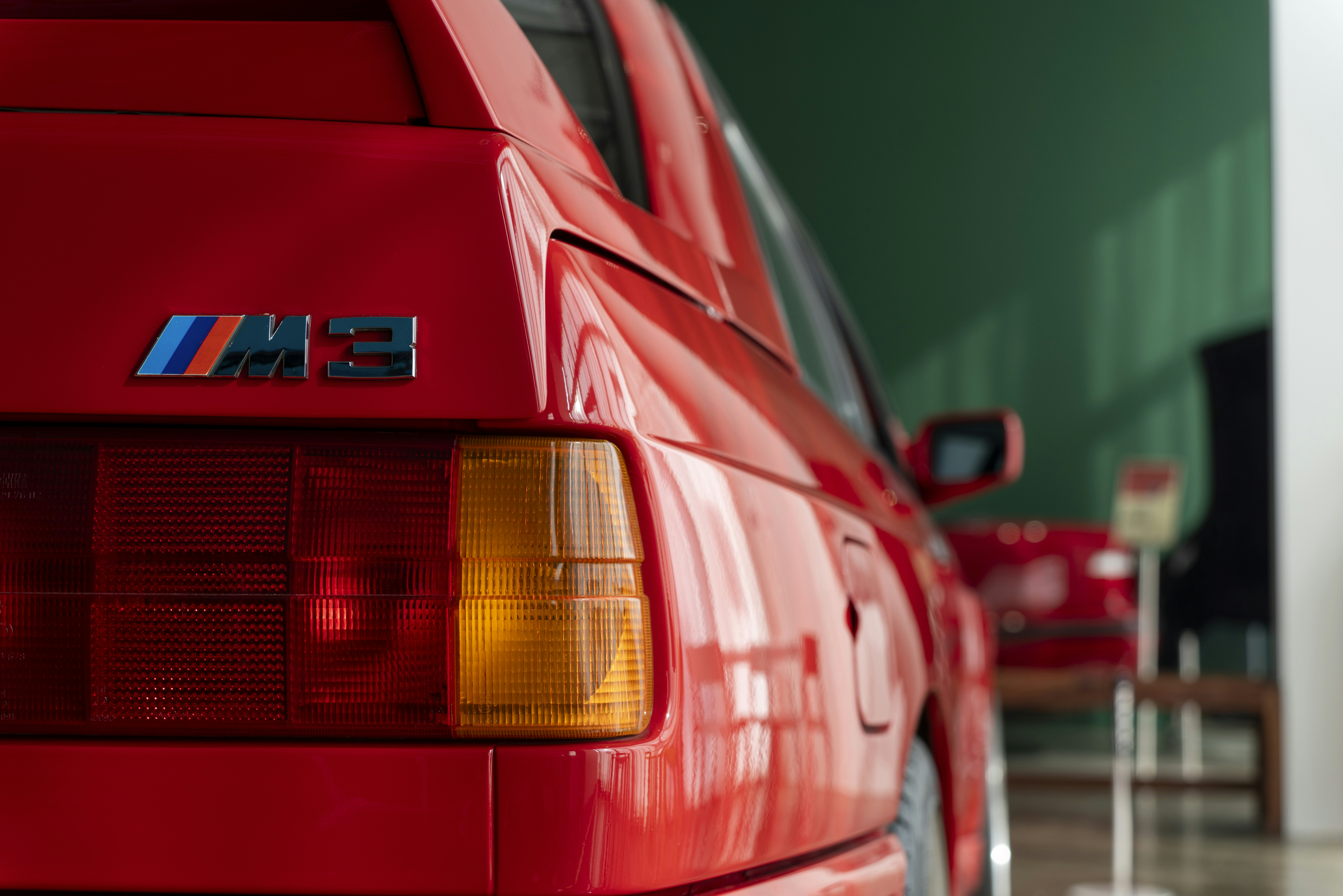a red bmw car parked in a garage
