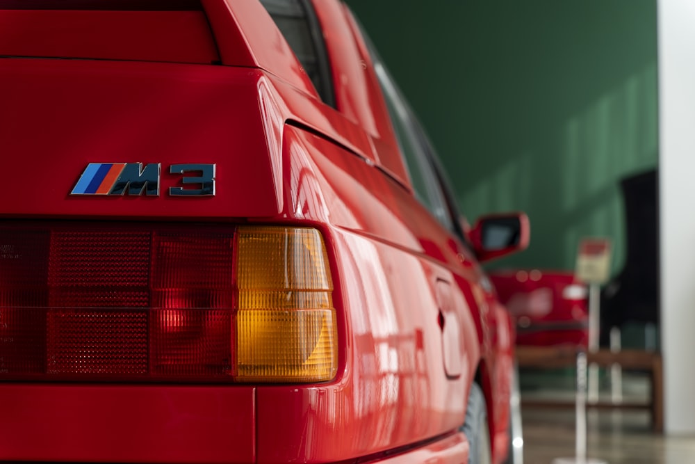 a red bmw car parked in a garage