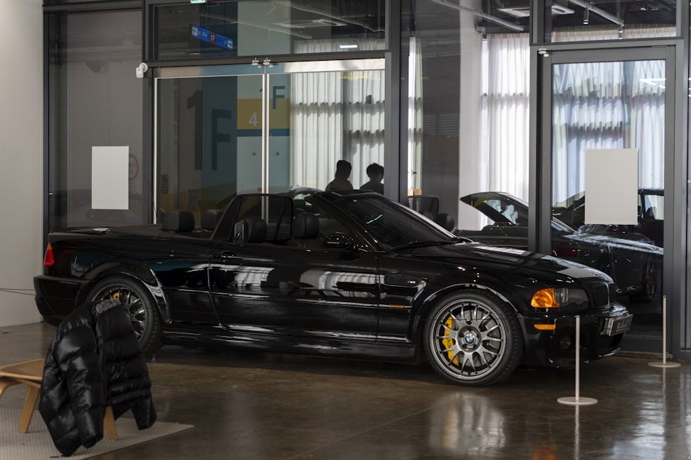 a black sports car parked in front of a building