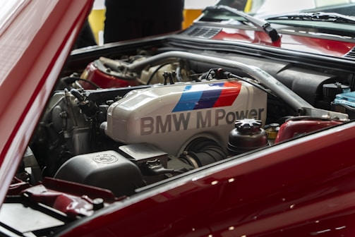 the engine compartment of a red car with bmw power written on it