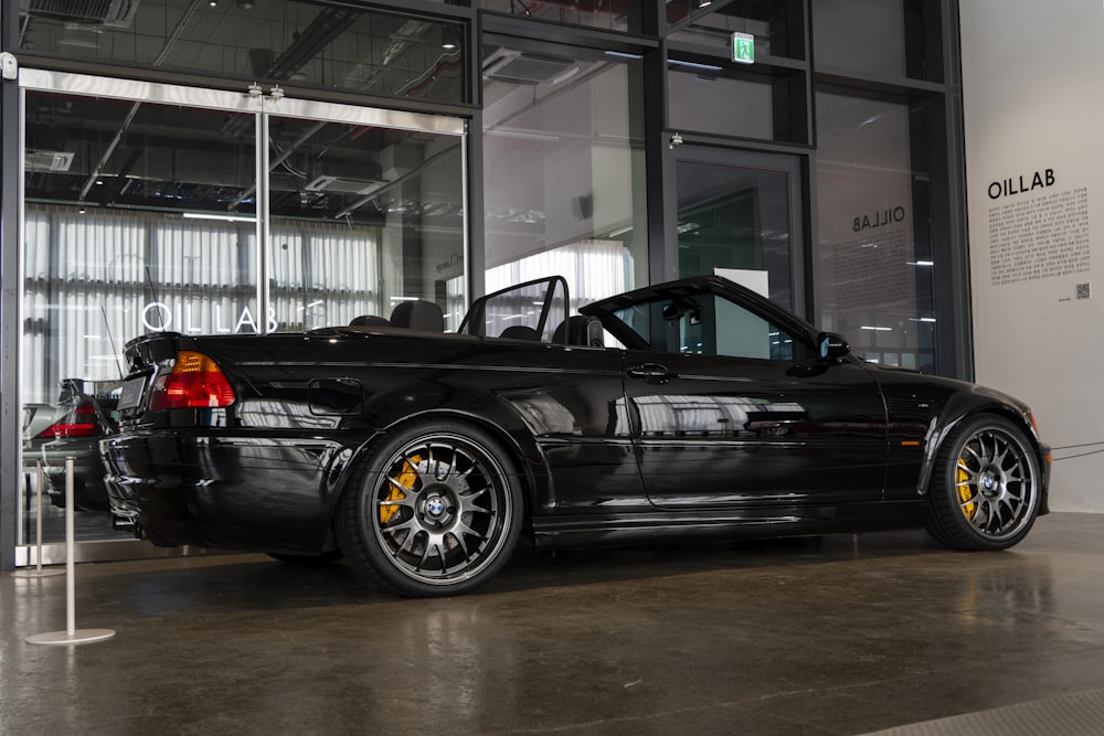 a black sports car parked in front of a building