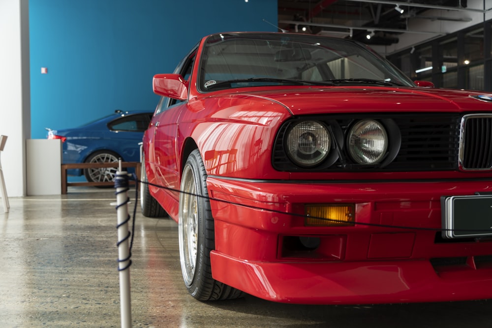 a red sports car parked in a garage