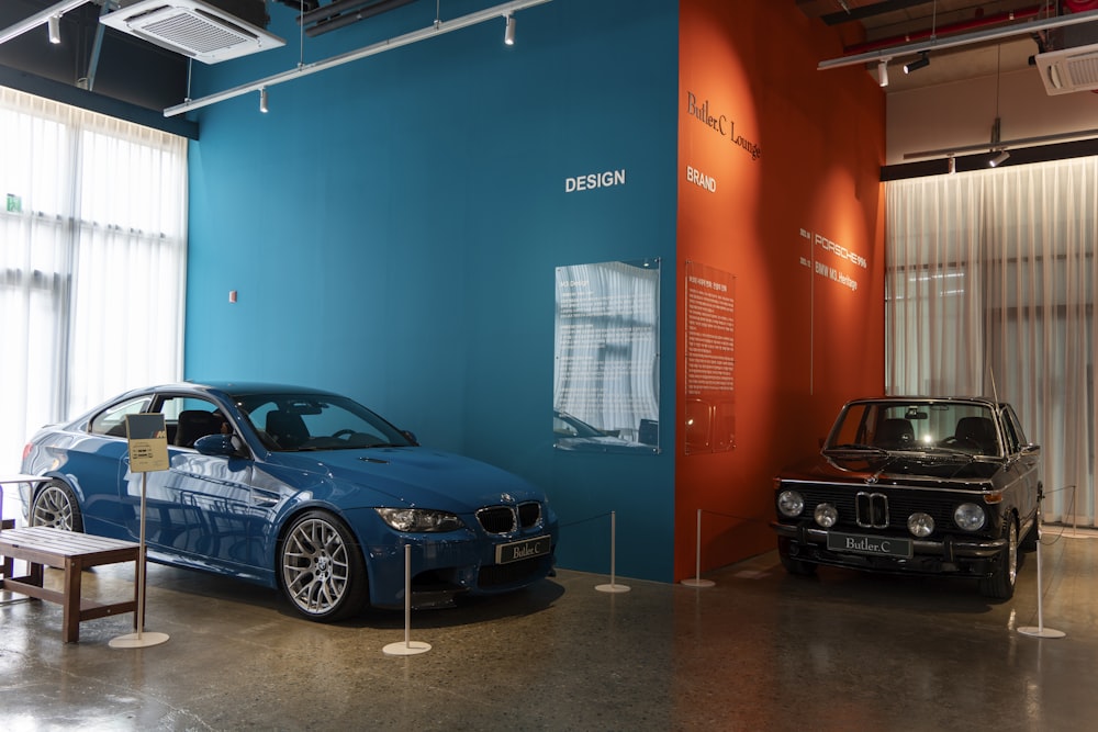 a blue car parked in front of a blue wall