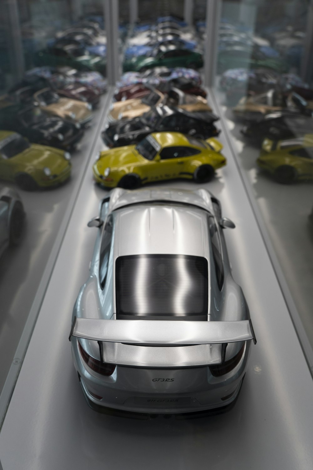 a row of cars sitting on top of a display case
