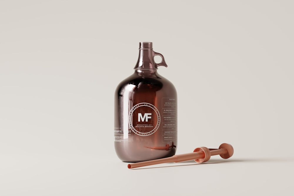 a brown bottle with a wooden spoon next to it