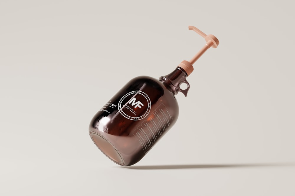 a brown bottle with a brown handle and a brown cap