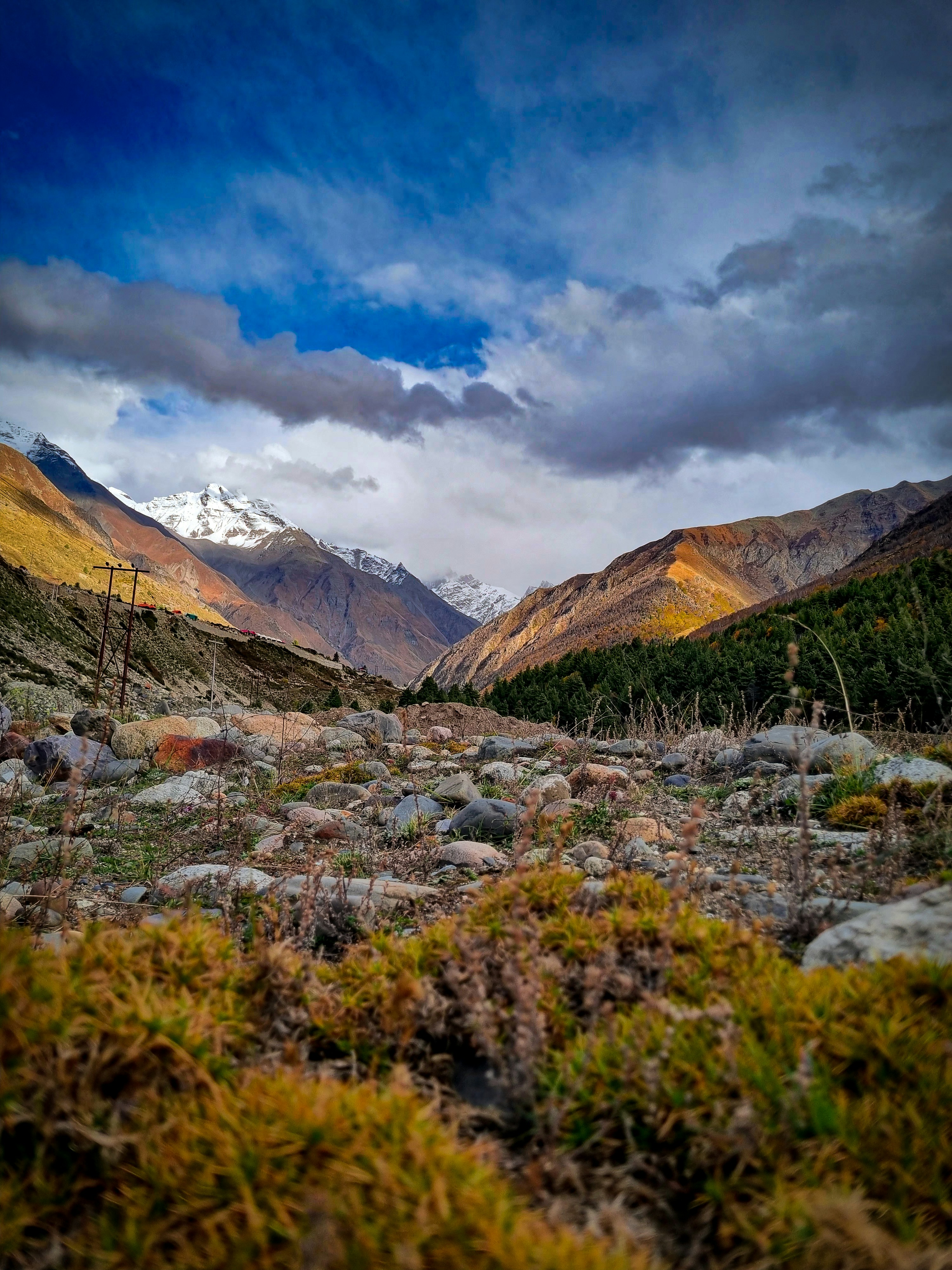 A view of a valley with mountains in the background photo – Free ...