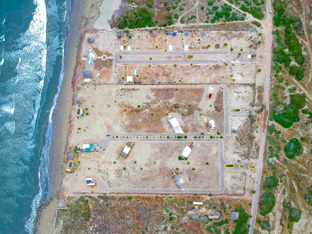 an aerial view of a construction site next to the ocean