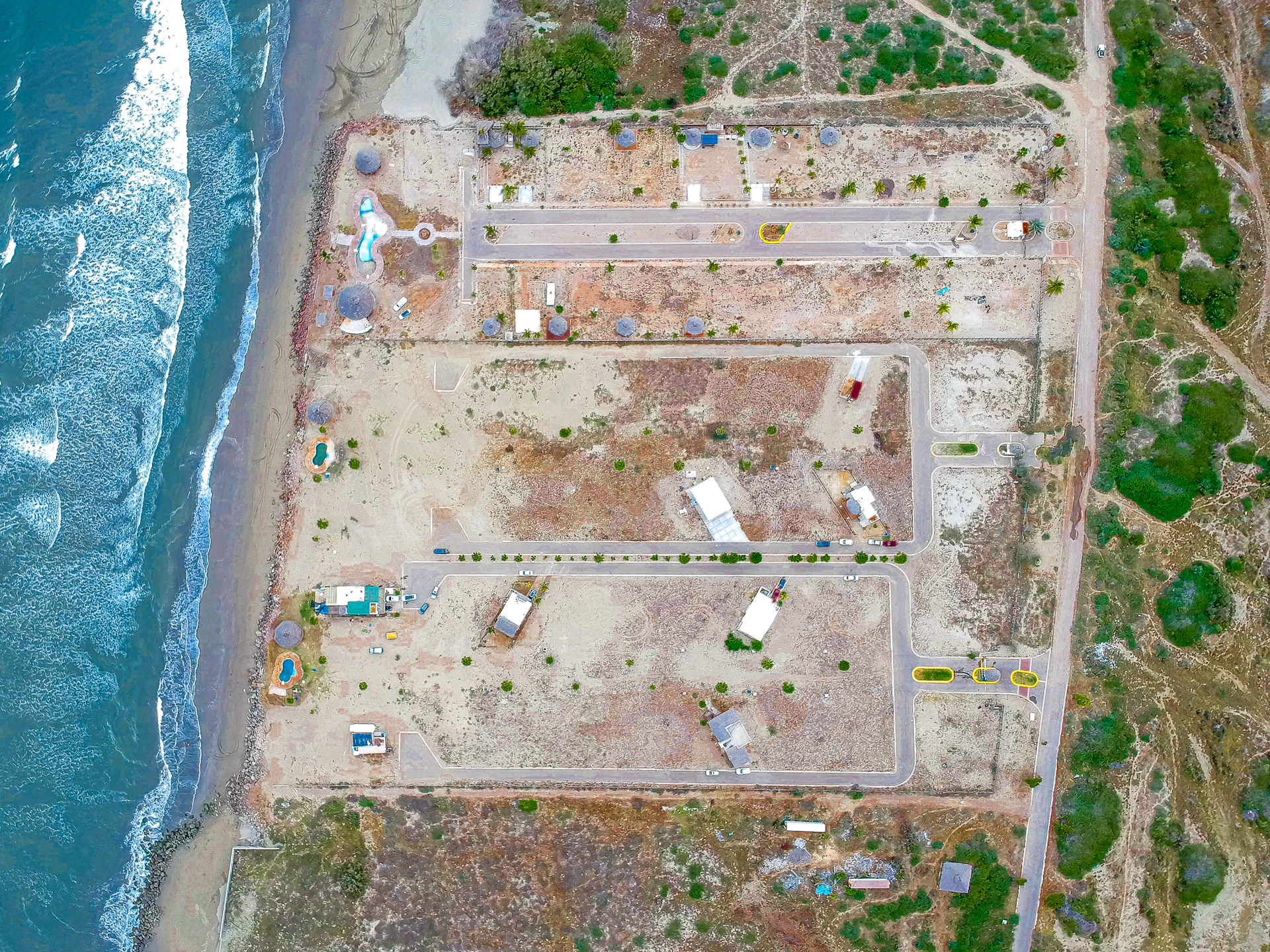 an aerial view of a construction site next to the ocean