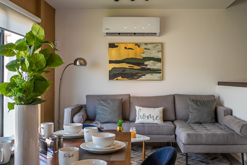 a living room filled with furniture and a painting on the wall