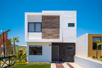 a white house with a black door and windows