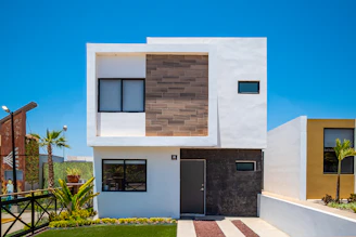a white house with a black door and windows