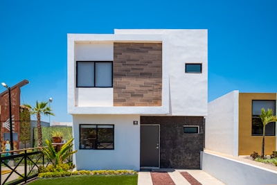 a white house with a black door and windows