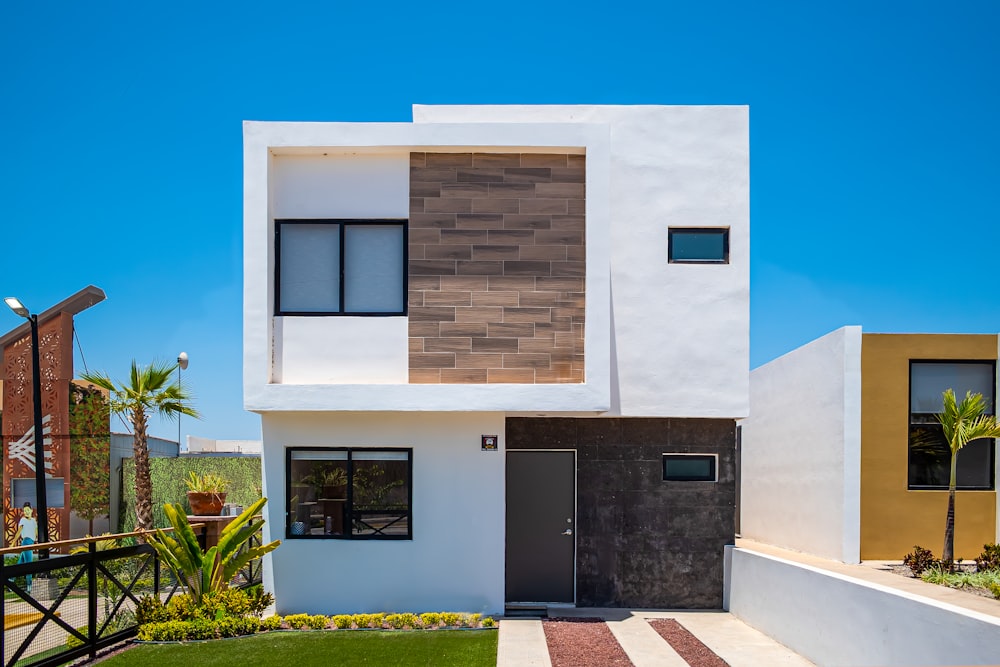 a white house with a black door and windows