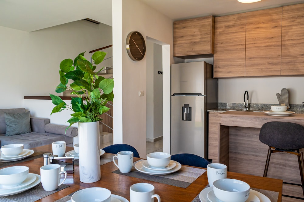 a dining room table with plates and cups on it