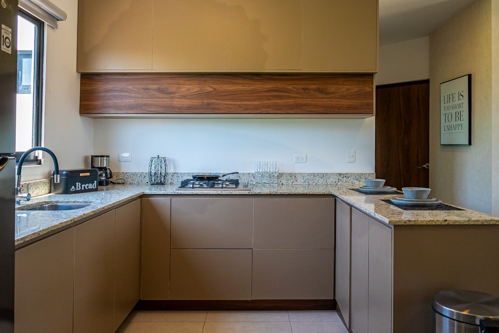 a kitchen with a stove top oven sitting under a window