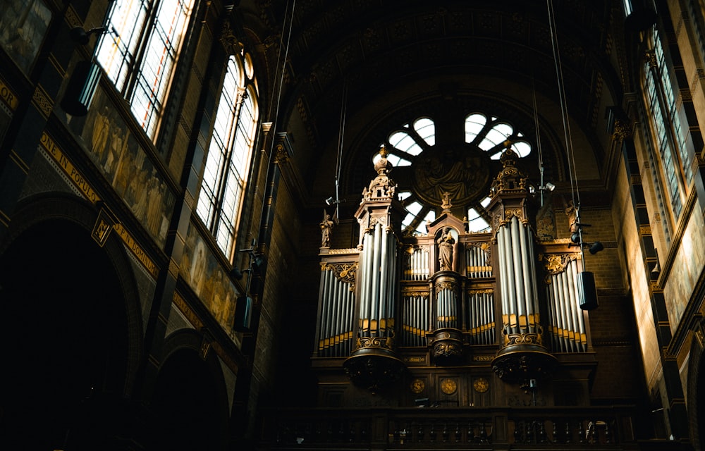 a large pipe organ in a church with stained glass windows