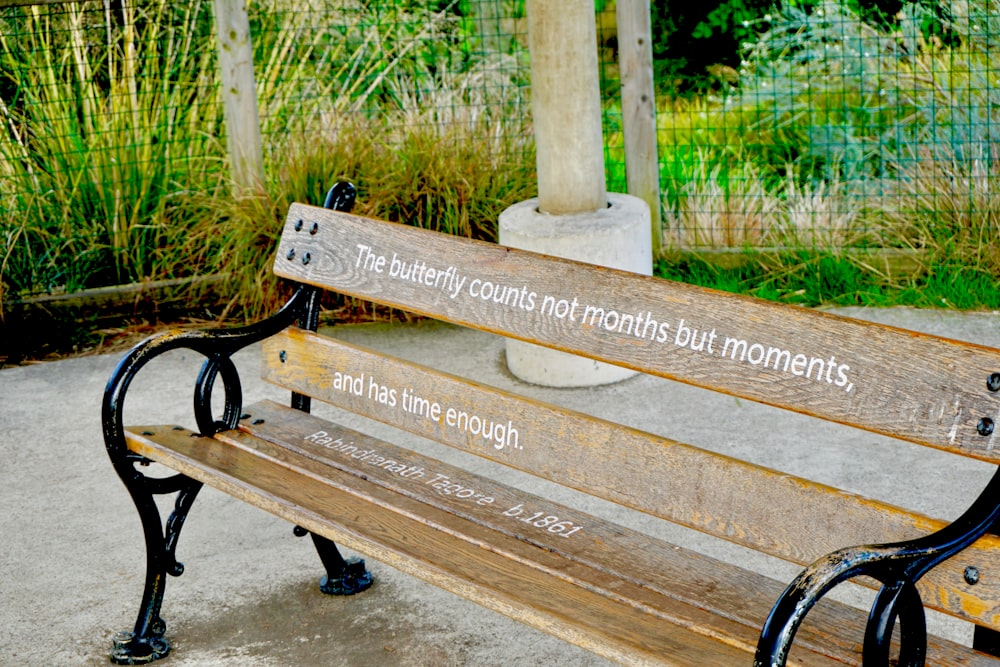 a wooden bench with a poem written on it