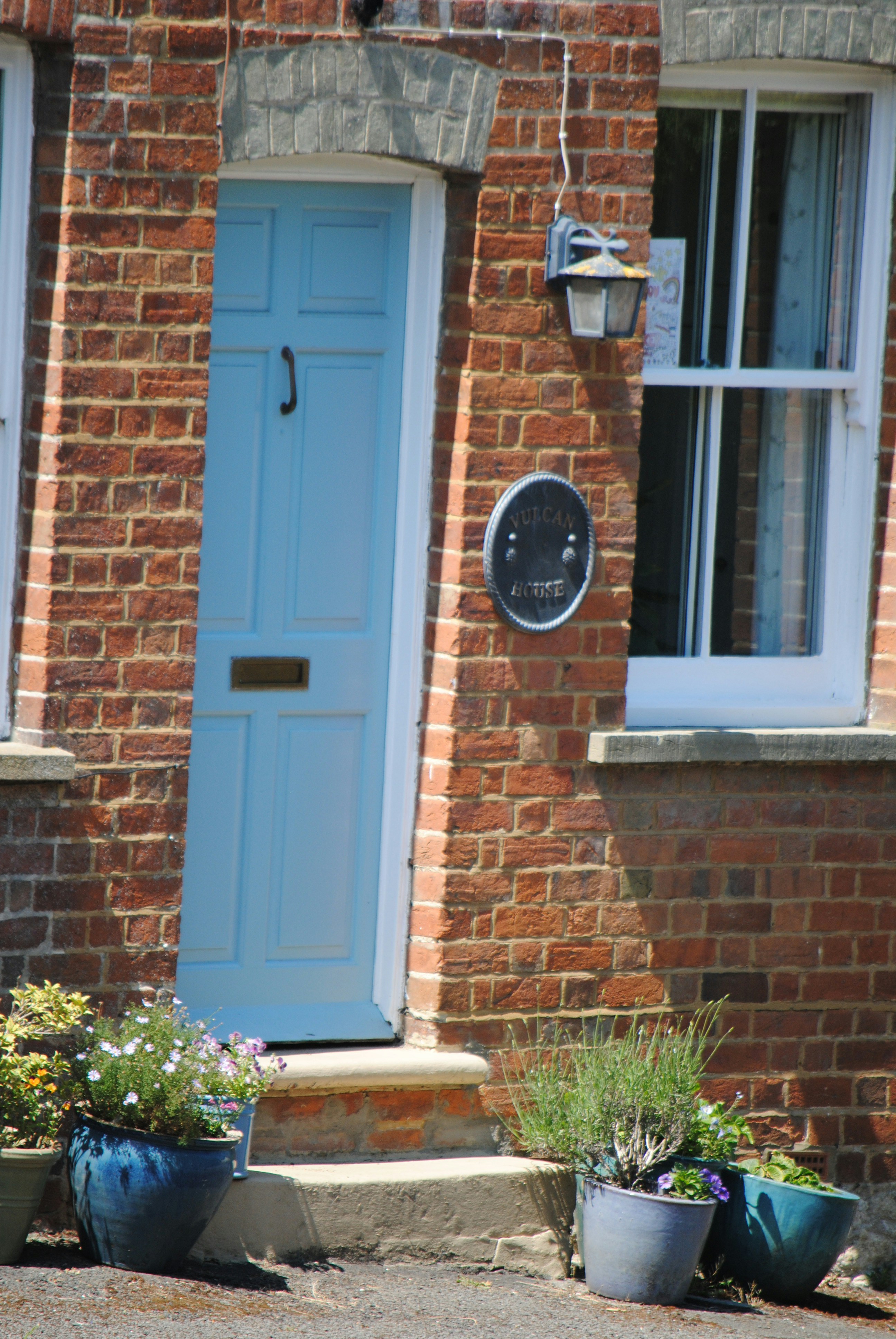 a blue door and window on a brick building