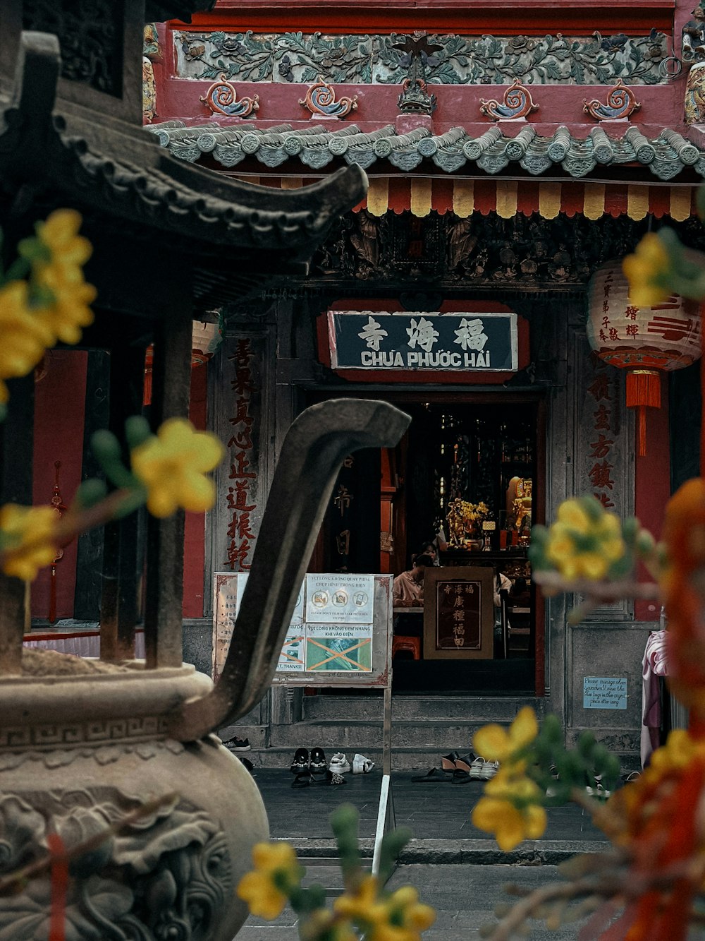 a chinese temple with flowers in the foreground