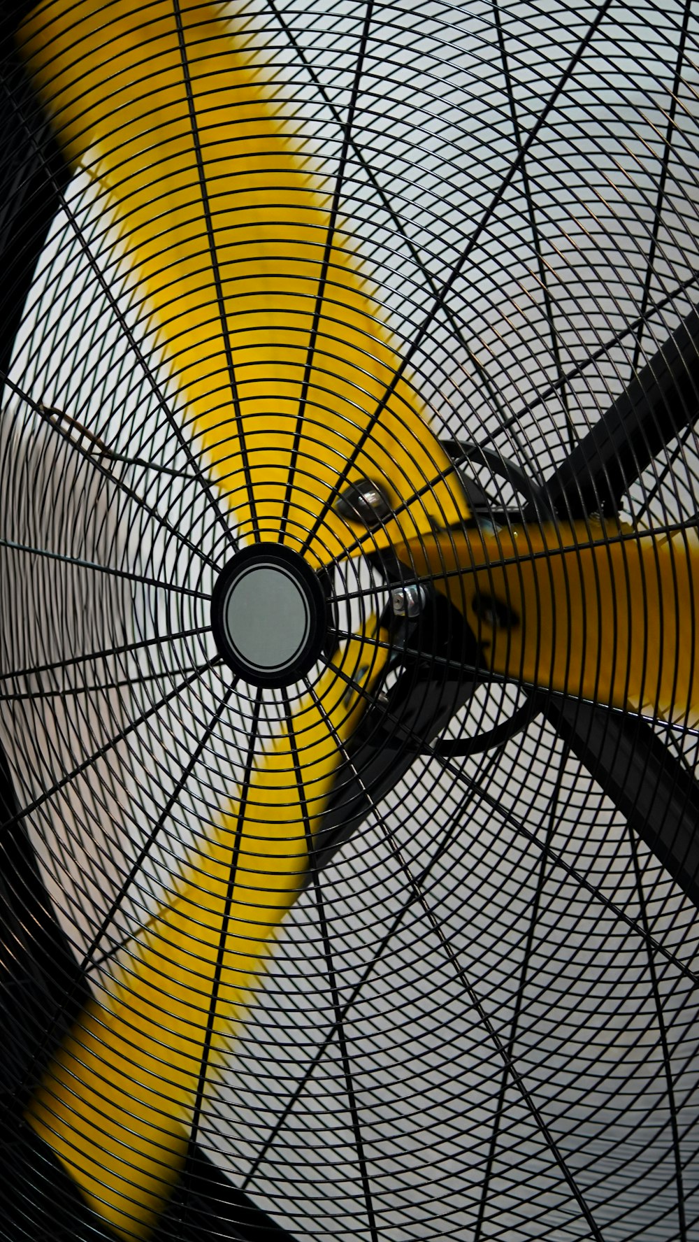 a close up of a yellow and black fan