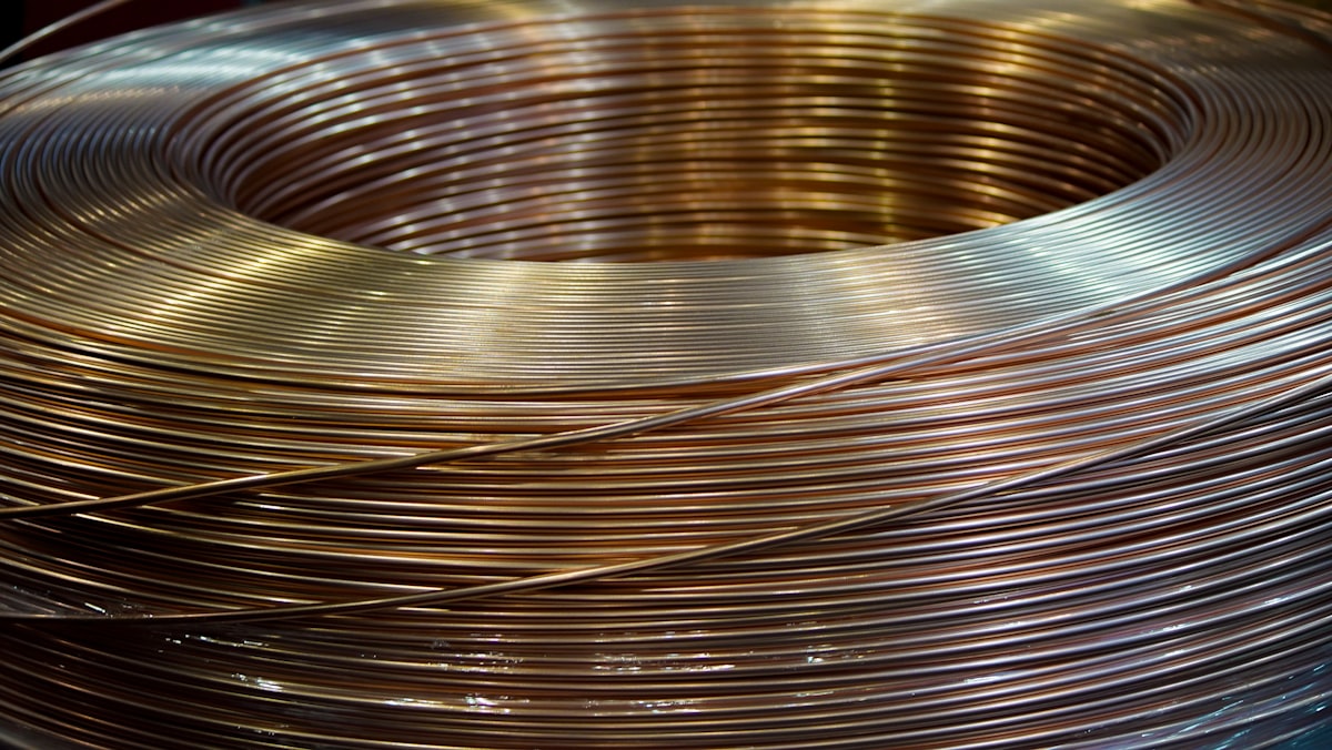 A coil of copper wire on a table representing copper commodity markets