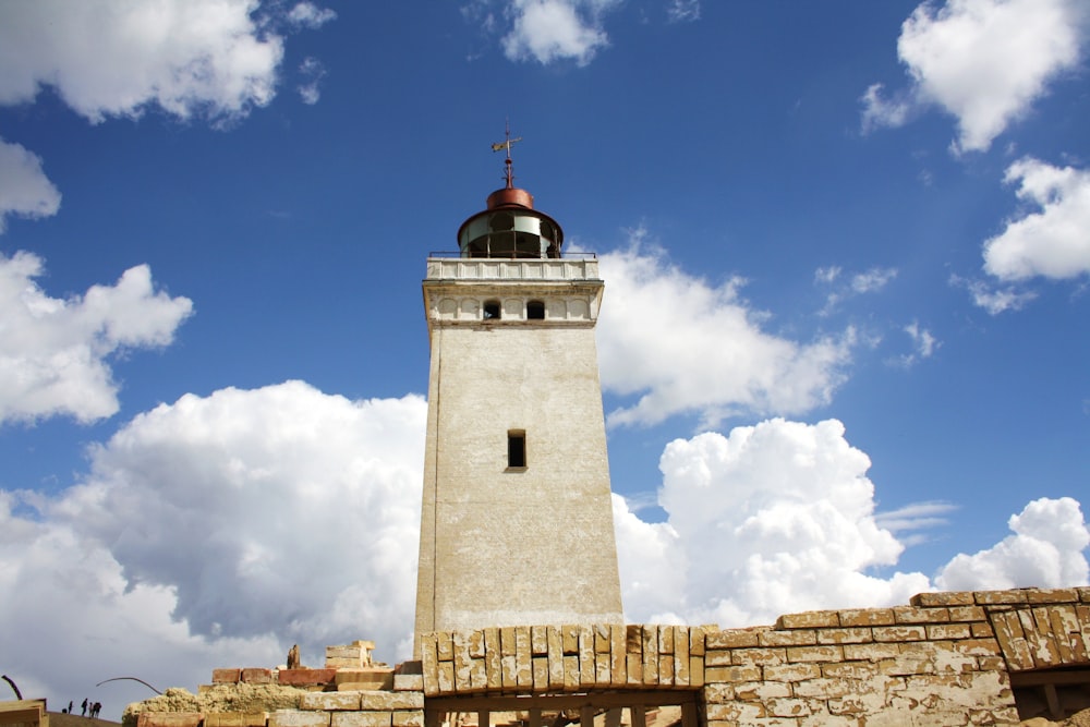 a tall tower with a cross on top of it