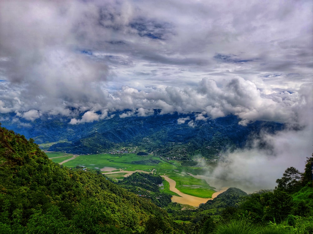 a scenic view of a valley surrounded by mountains