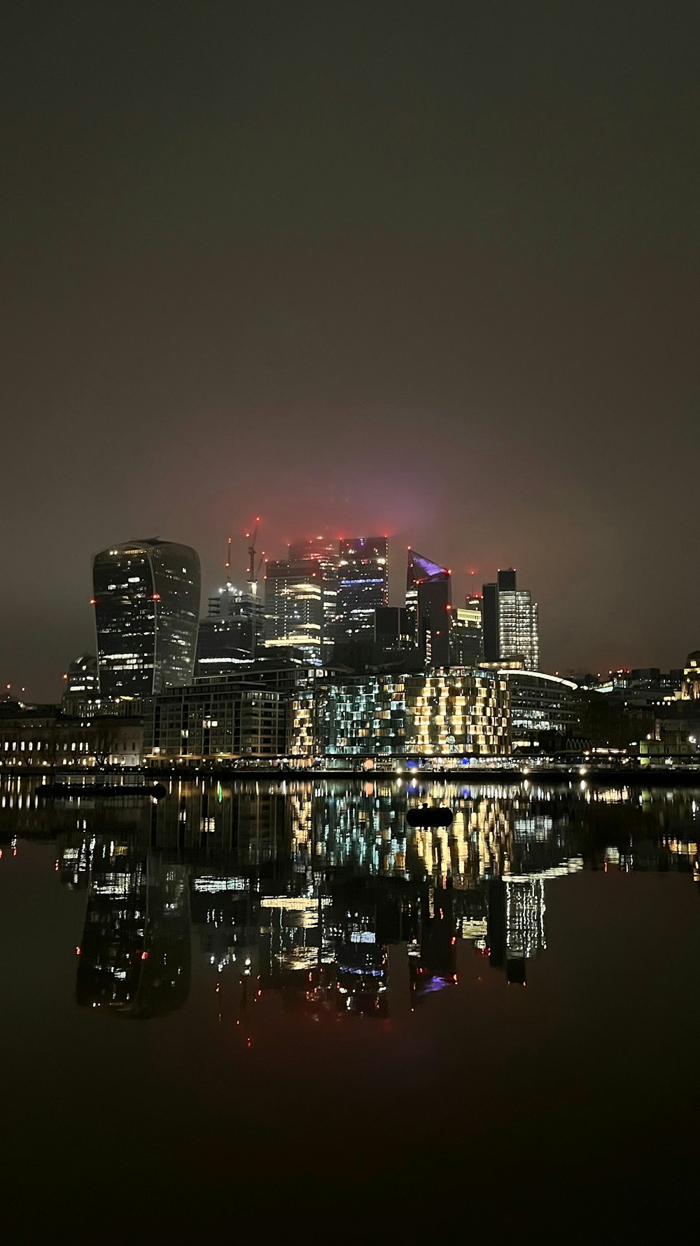 a city skyline is lit up at night