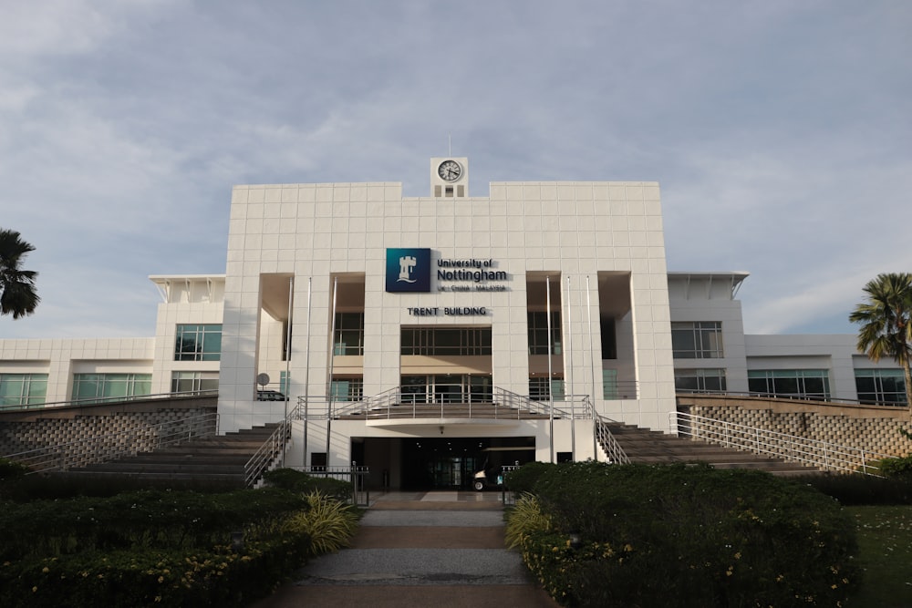 a large white building with a clock on the top of it