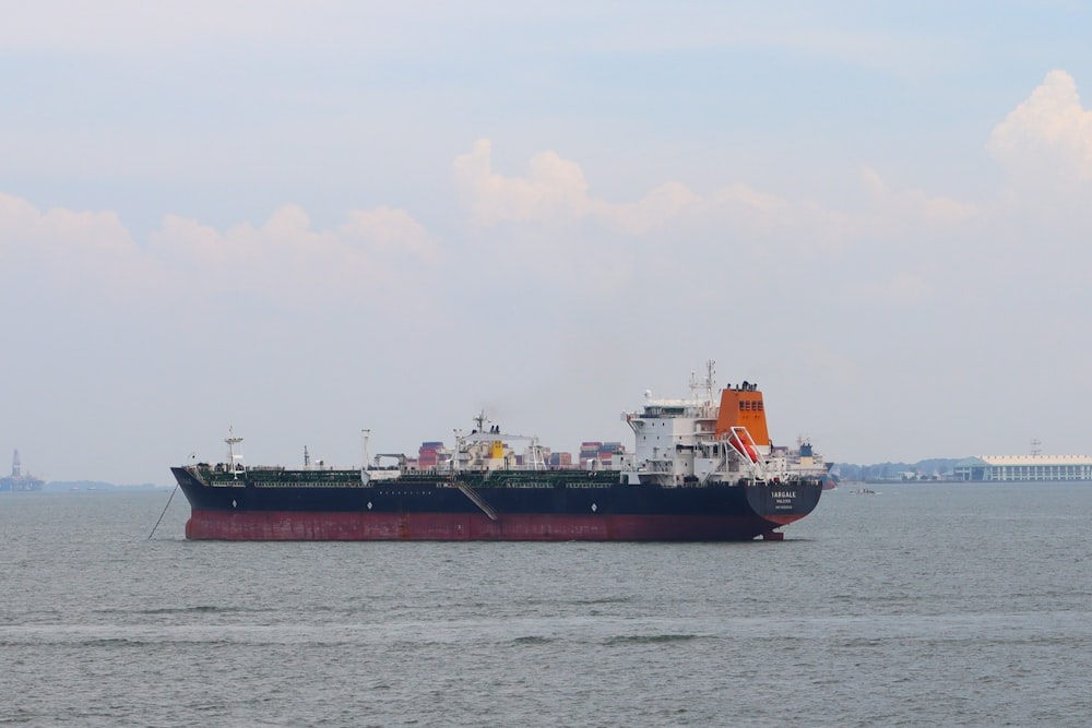 a large cargo ship floating on top of a large body of water