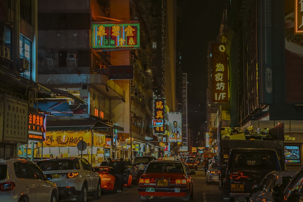 a city street filled with lots of traffic at night