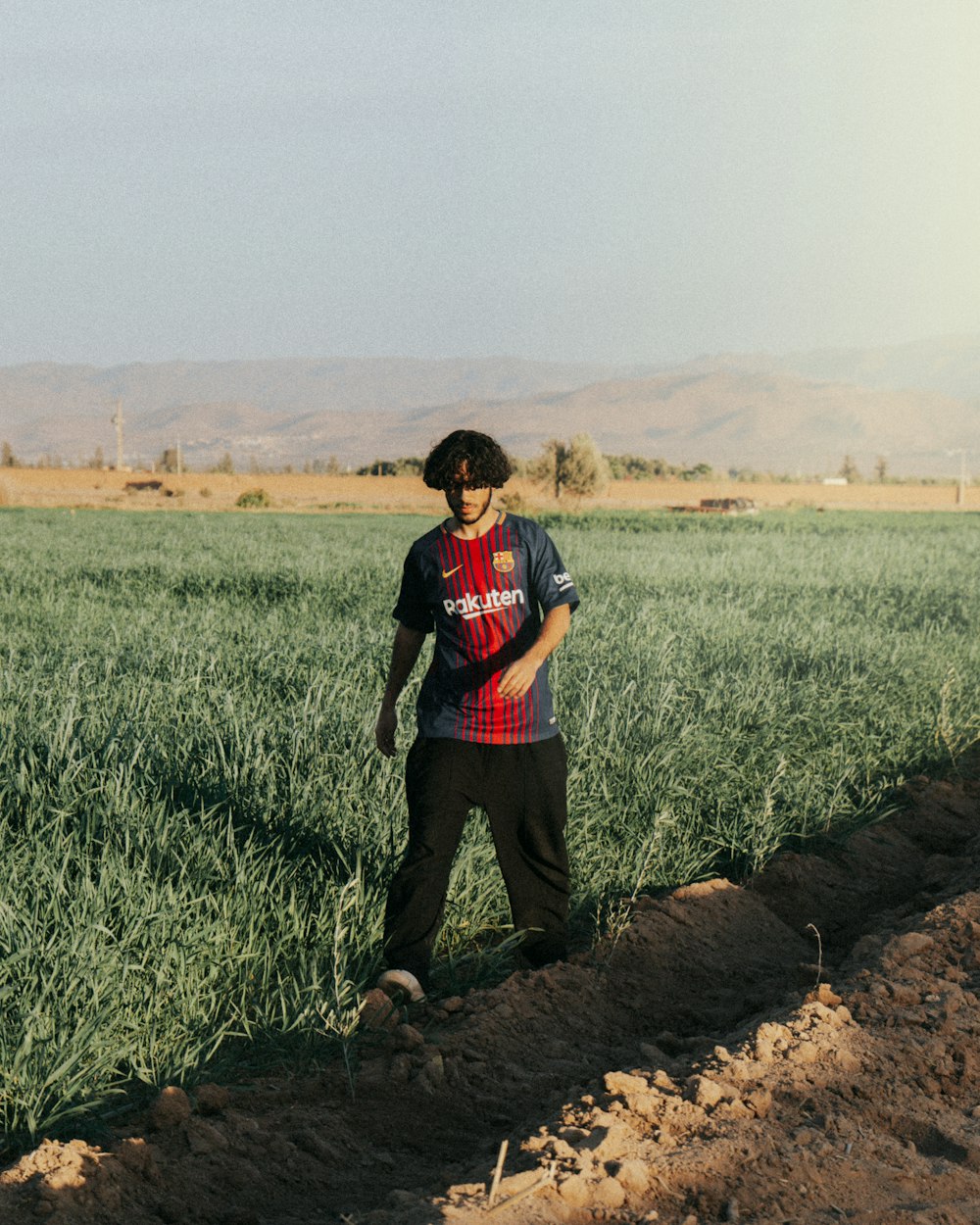 a man standing in a field of green grass