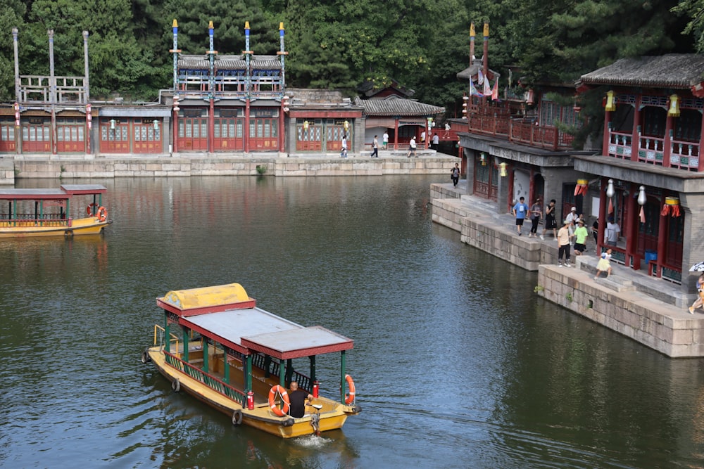 a yellow boat floating on top of a body of water