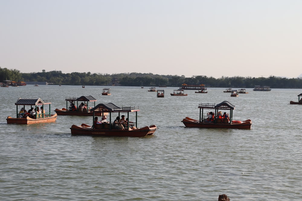 a group of boats floating on top of a lake