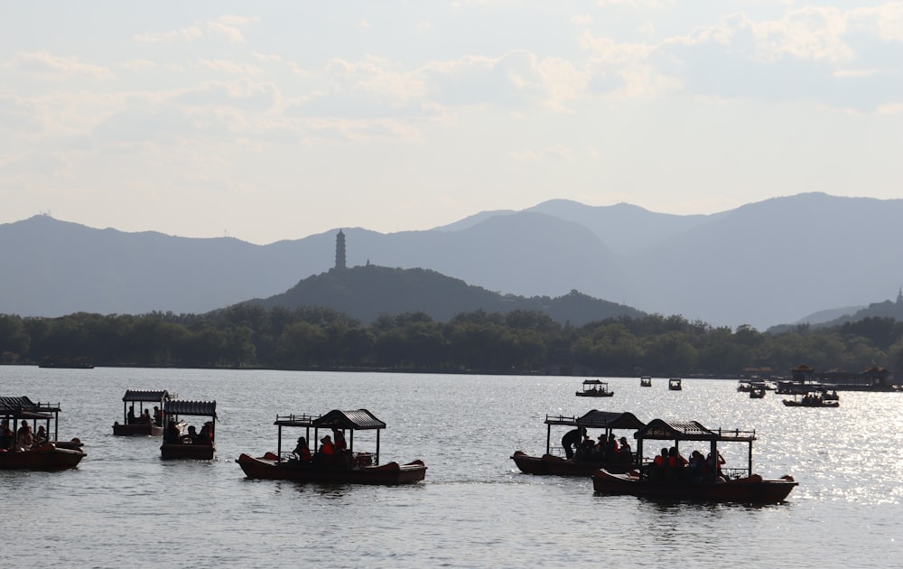 a group of boats floating on top of a lake